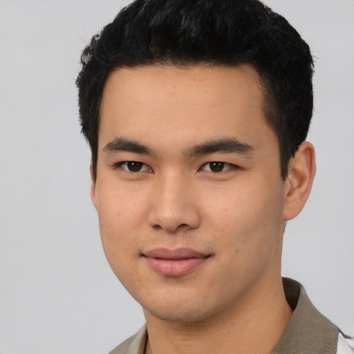 Joyful asian young-adult male with short  black hair and brown eyes
