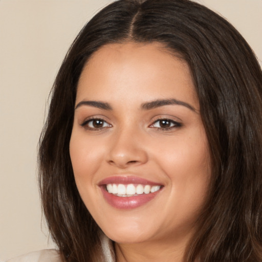 Joyful white young-adult female with long  brown hair and brown eyes