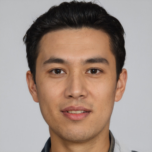 Joyful asian young-adult male with short  black hair and brown eyes