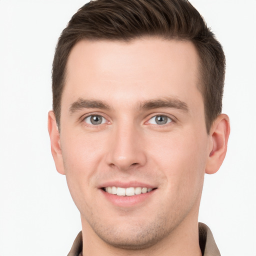 Joyful white young-adult male with short  brown hair and grey eyes