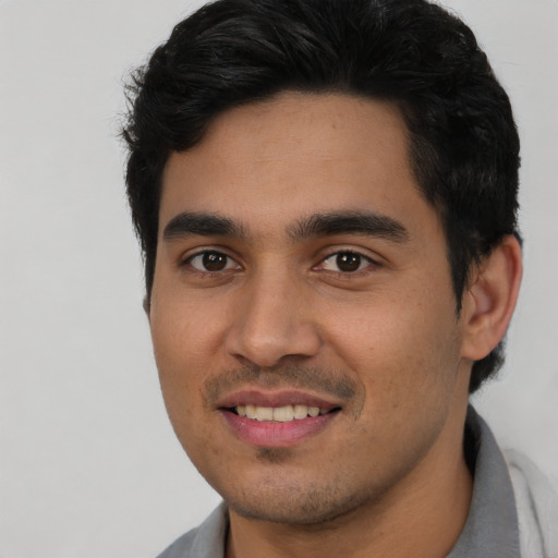 Joyful asian young-adult male with short  black hair and brown eyes