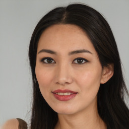 Joyful asian young-adult female with long  brown hair and brown eyes