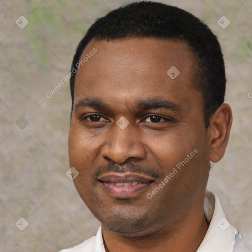 Joyful black young-adult male with short  black hair and brown eyes
