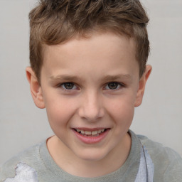 Joyful white child male with short  brown hair and brown eyes