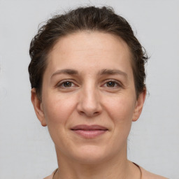 Joyful white adult female with short  brown hair and grey eyes