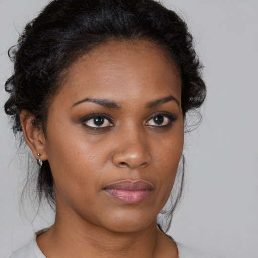 Neutral black young-adult female with medium  brown hair and brown eyes