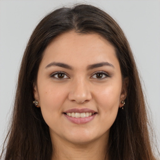 Joyful white young-adult female with long  brown hair and brown eyes