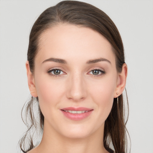 Joyful white young-adult female with long  brown hair and grey eyes