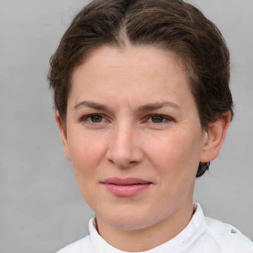 Joyful white young-adult female with short  brown hair and grey eyes