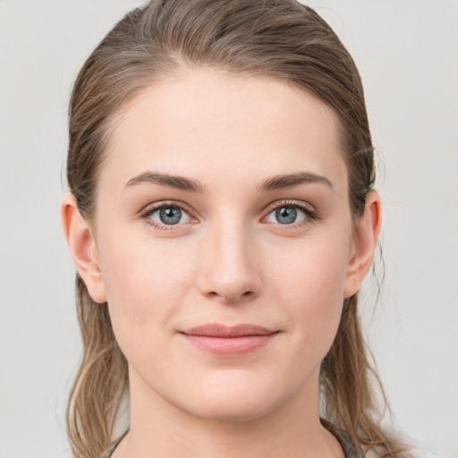 Joyful white young-adult female with long  brown hair and grey eyes