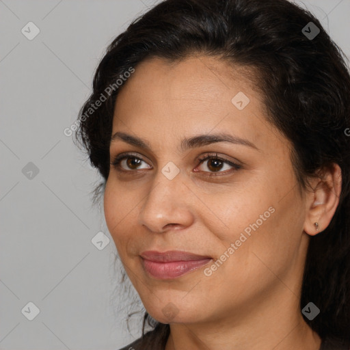 Joyful latino adult female with medium  brown hair and brown eyes