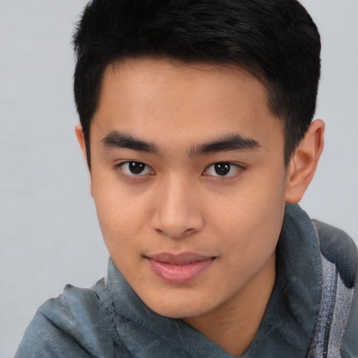 Joyful asian young-adult male with short  brown hair and brown eyes