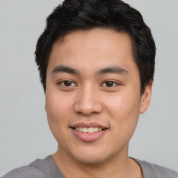 Joyful asian young-adult male with short  black hair and brown eyes