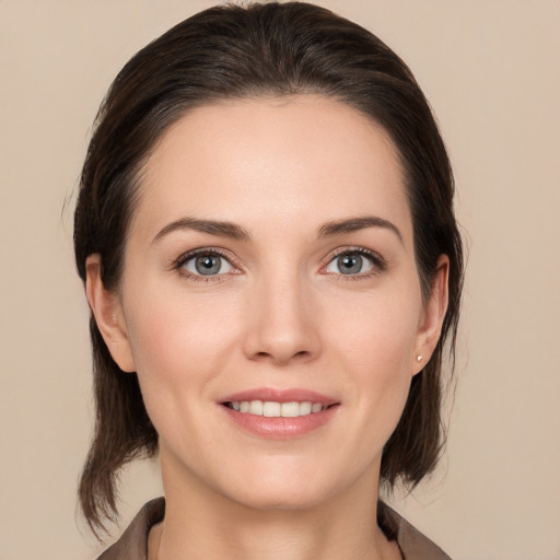 Joyful white young-adult female with medium  brown hair and brown eyes