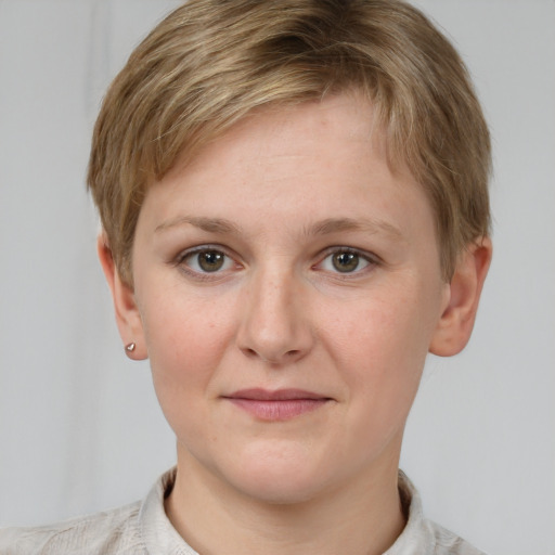 Joyful white young-adult female with short  brown hair and grey eyes