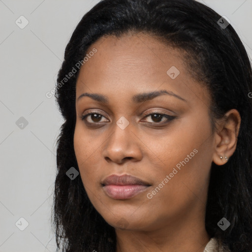 Joyful black young-adult female with long  black hair and brown eyes