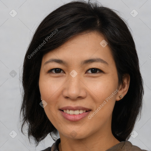 Joyful asian adult female with medium  brown hair and brown eyes