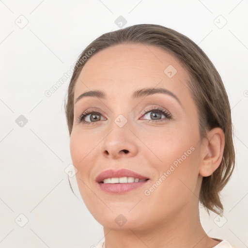 Joyful white young-adult female with medium  brown hair and grey eyes