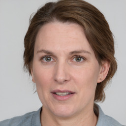 Joyful white adult female with medium  brown hair and grey eyes