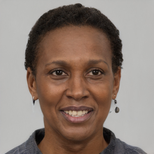 Joyful black adult female with short  black hair and brown eyes