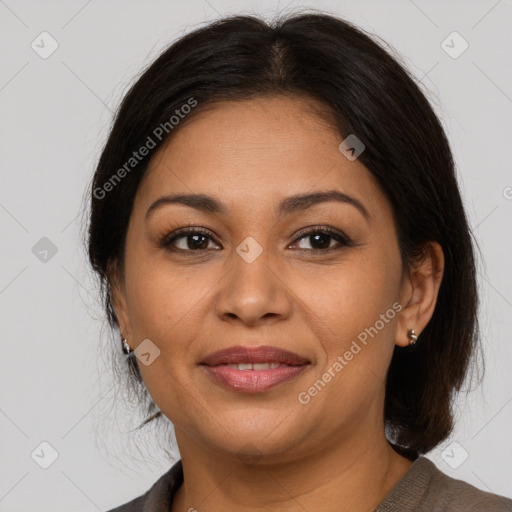 Joyful latino adult female with medium  brown hair and brown eyes