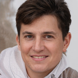 Joyful white adult male with short  brown hair and brown eyes