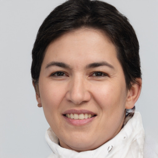 Joyful white adult female with short  brown hair and brown eyes