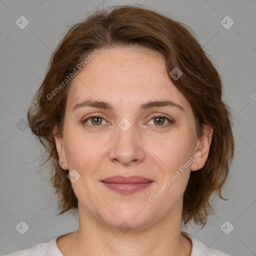 Joyful white adult female with medium  brown hair and green eyes