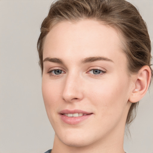 Joyful white young-adult female with medium  brown hair and blue eyes