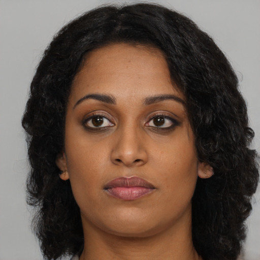 Neutral black young-adult female with long  brown hair and brown eyes