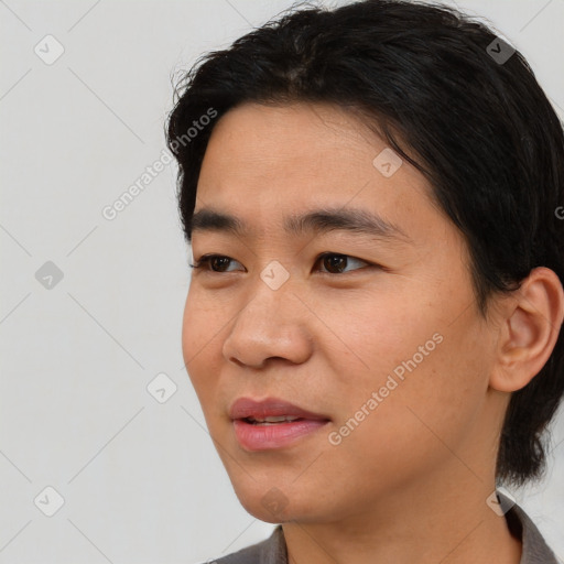 Joyful asian young-adult male with short  black hair and brown eyes