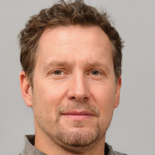 Joyful white adult male with short  brown hair and grey eyes