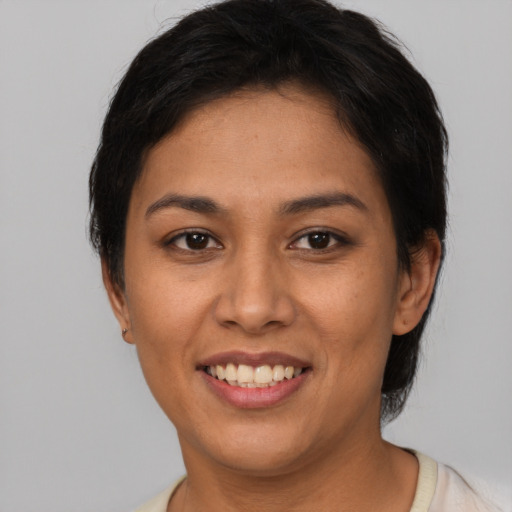 Joyful latino young-adult female with short  brown hair and brown eyes