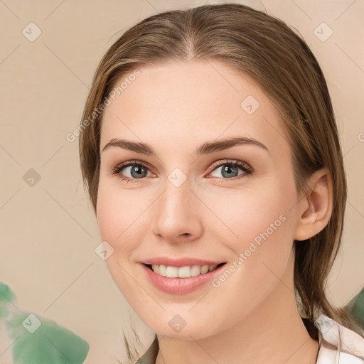 Joyful white young-adult female with medium  brown hair and green eyes