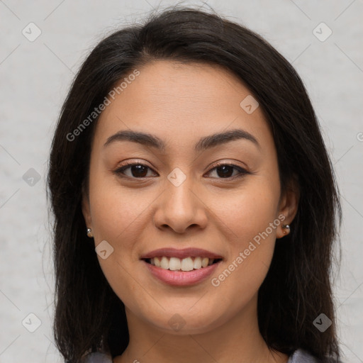 Joyful latino young-adult female with long  brown hair and brown eyes