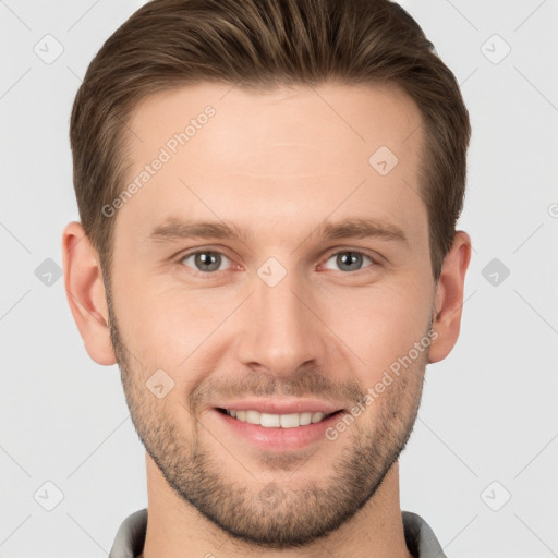 Joyful white young-adult male with short  brown hair and grey eyes