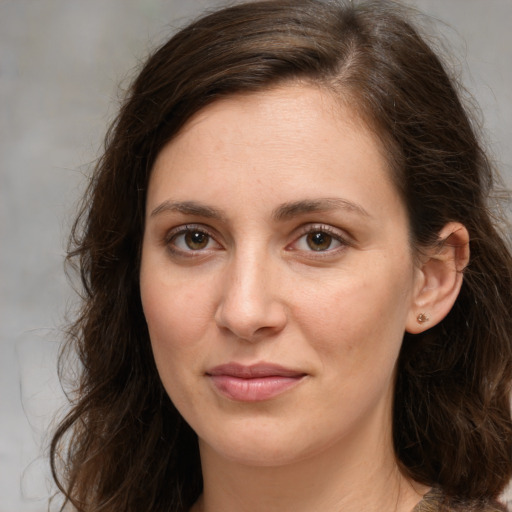 Joyful white young-adult female with medium  brown hair and green eyes