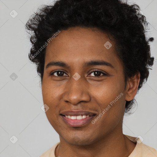 Joyful black young-adult male with short  brown hair and brown eyes