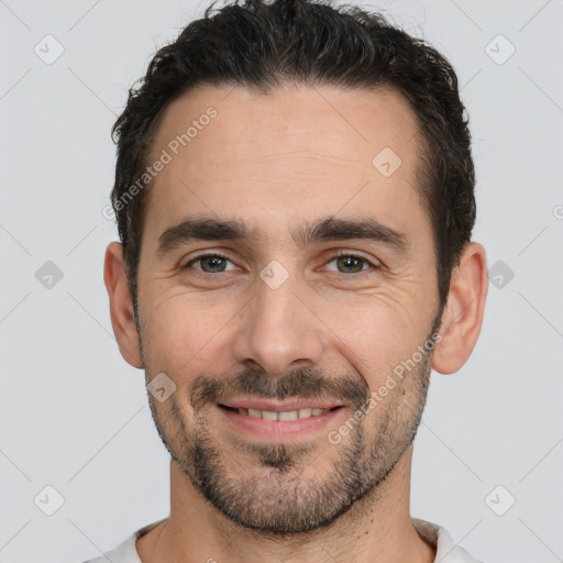 Joyful white young-adult male with short  black hair and brown eyes