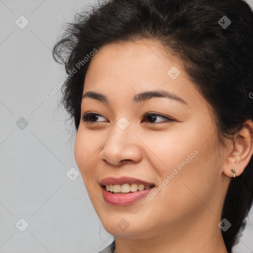 Joyful latino young-adult female with medium  brown hair and brown eyes