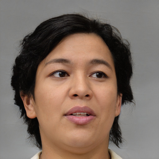 Joyful asian adult female with medium  brown hair and brown eyes