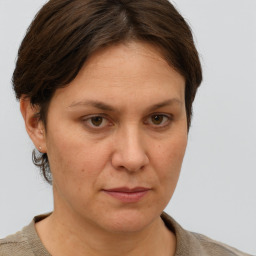 Joyful white adult female with short  brown hair and grey eyes