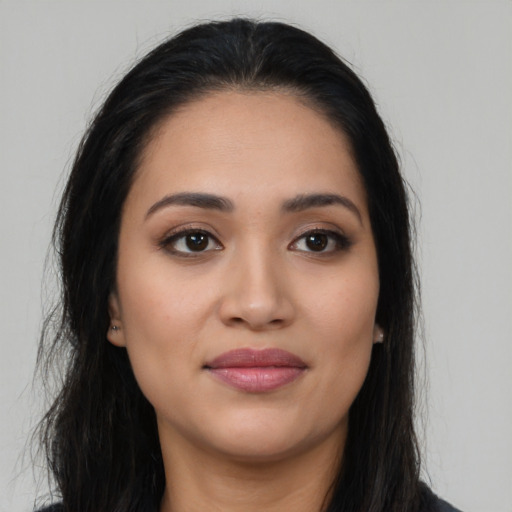 Joyful latino young-adult female with long  black hair and brown eyes