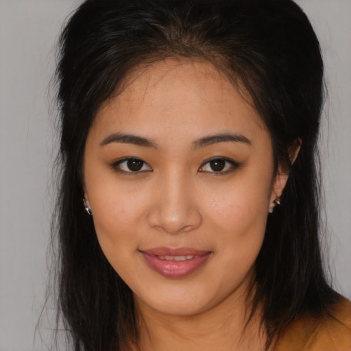 Joyful asian young-adult female with long  brown hair and brown eyes