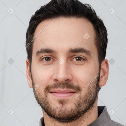 Joyful white young-adult male with short  brown hair and brown eyes