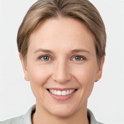 Joyful white adult female with short  brown hair and grey eyes