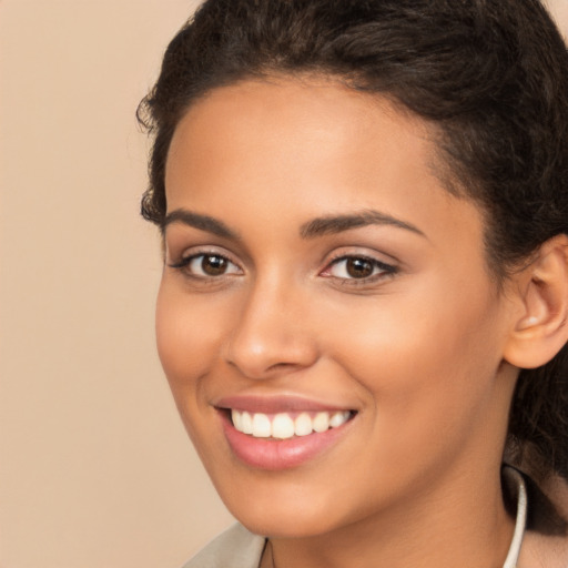 Joyful latino young-adult female with long  brown hair and brown eyes