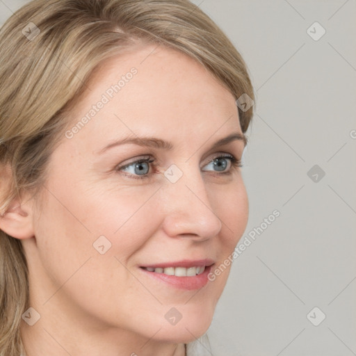 Joyful white young-adult female with medium  brown hair and blue eyes