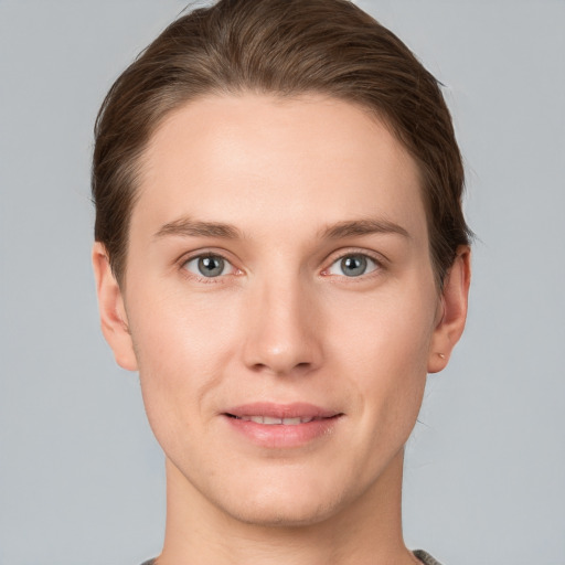 Joyful white young-adult female with short  brown hair and grey eyes