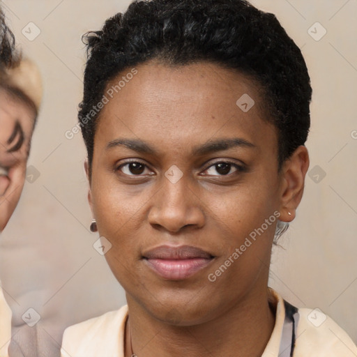 Joyful black young-adult female with short  black hair and brown eyes